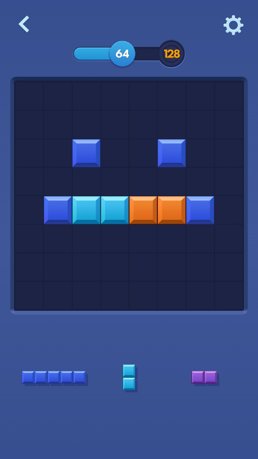 Das Bild zeigt eine Smartphone-App mit einem Blockspiel. Oben auf dem Bildschirm befinden sich die Zahlen 64 und 128. In der Mitte des Bildschirms befindet sich ein Raster mit verschiedenfarbigen Blöcken. Die Blöcke sind so angeordnet, dass sie ein Gesicht darstellen. Unterhalb des Gitters befinden sich weitere Blöcke in verschiedenen Farben und Formen, die darauf warten, platziert zu werden. Die Gesamtumgebung ist dunkelblau.